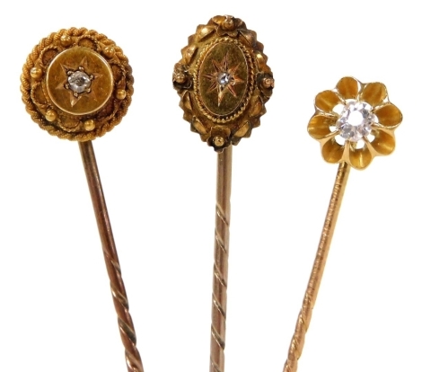 Three Victorian tie pins, each centrally set with an old cut or rose cut diamond in yellow metal, 5.2g.