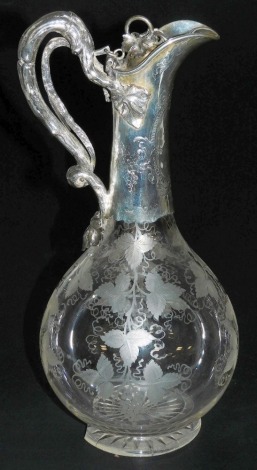 A Victorian etched glass and silver mounted claret jug, the mount decorated with applied leaves and engraved scroll and floral decoration, with a cast bark handle, the globular body etched with leaves and vines on a circular foot, James Charles Edington, 