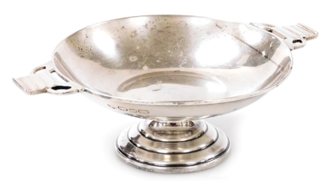 A 20thC Indian Colonial twin handled pedestal sweetmeat dish, each handle of stepped form with pierced decoration, Hamilton and Co., stamped with an elephant and date letter F, sterling silver, 3.08oz, 4cm high.