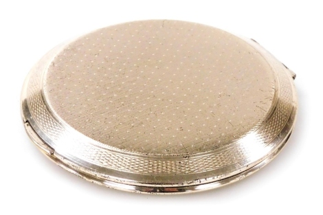 An Elizabeth II silver compact, with engine turned decoration, London 1967, 3.05oz all in.