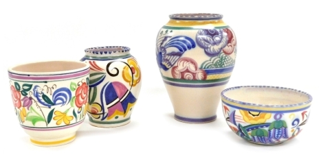 A group of Poole pottery, comprising a vase of cylindrical tapering form, decorated with a band of flowers within further multicoloured bands, 18cm high, a bowl decorated with flowers and abstract patterns, 13cm diameter, and two further vases. (4)