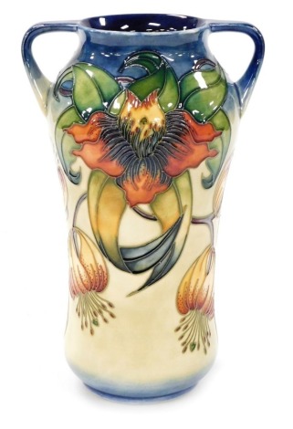 A Moorcroft pottery two handled vase decorated in the Anna Lily pattern, impressed and painted marks, 26cm high.