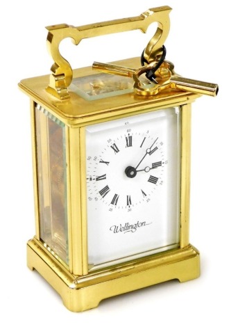 A 20thC brass cased carriage clock, the white enamel dial bearing Roman numerals for Wellington, key wind single barrel movement, the case with ring handle, with key, 11cm high.