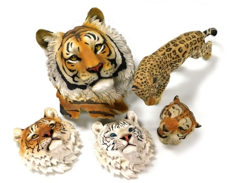 A group of resin wall masks, modelled as tiger's heads, and a further figure of a leopard. (5)