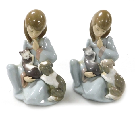 A pair of Lladro porcelain figures, each modelled as a seated girl with a puppy and kitten.