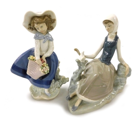 A Lladro porcelain figure of a girl, modelled resting against a rock with a dove before her, and a further figure of a girl with a basket of flowers. (2)