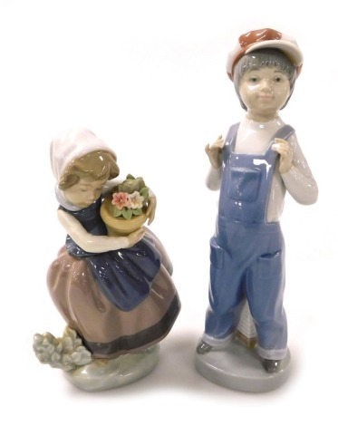 A Lladro porcelain figure modelled as a boy standing in dungarees, with a squeeze box, and a girl with a pot of flowers. (2)