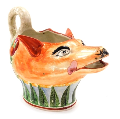 An early 19thC Staffordshire pearlware sauce boat, modelled as a fox's head, with a swan handle, 17cm wide.