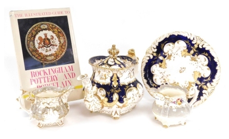 A group of early 19thC porcelain, including a teapot and stand, the lid with crown finial, two cream jugs, together with the Illustrated Guide to Rockingham Pottery and Porcelain by DG Rice. (5)