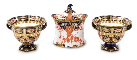 A pair of late 19thC Royal Crown Derby porcelain twin handled sweet meat dishes, Imari decorated, printed and painted marks, 10cm wide, together with an Imari porcelain sucrier and cover, circa 1897, Imari decorated, printed marks. (3)