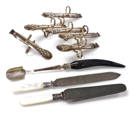 A set of six silver plated asparagus servers, together with a plated stilton scoop with simulated horn handle, and a cake slice, and knife, with mother of pearl handles.