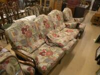 An Ercol oak framed cottage suite comprising three seater sofa