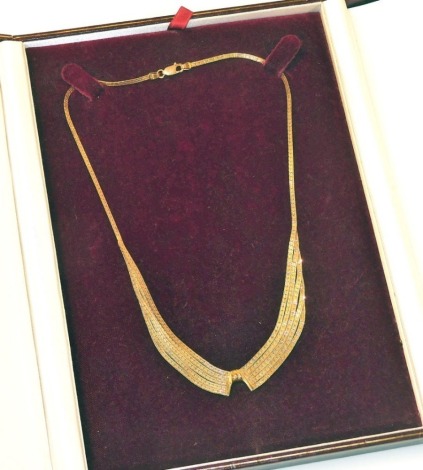 A 9ct gold four stand fringe necklace, on a lobster claw clasp, boxed, 11.4g.