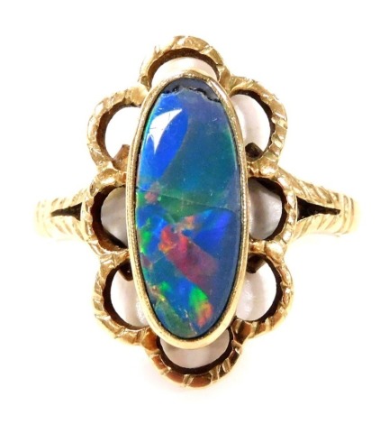 A 9ct gold and imitation opal triplet ring, the oval set stone in a floral leaf surround, size M, 3.2g.