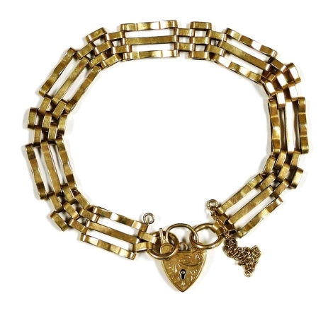 A 9ct gold three bar gate bracelet, on a heart shaped padlock clasp, with safety chain as fitted, 10.5g.