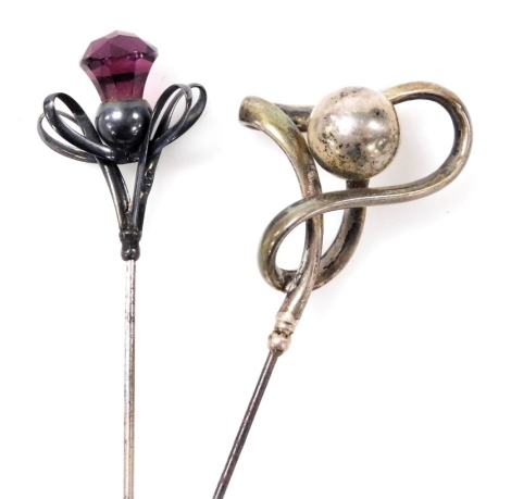 Two Charles Horner silver hat pins, comprising one of scroll and ball design, and another of scroll design with a thistle terminal.