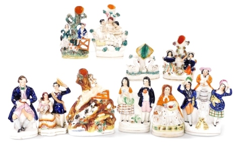 A group of 19thC Staffordshire figures, including a seated figure of a snuff taker, and a dancing figure group, flanking a man seated on a barrel plating an oboe, together with figural spill vases. (10)