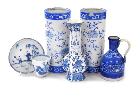 A pair of Qing Dynasty blue and white cylindrical porcelain vases, decorated with flowers, 24cm high, Kangxi porcelain cup decorated in blue and white with flowers and a saucer decorated with figures, Delft blue and white vase, and a blue glazed jug. (6, 