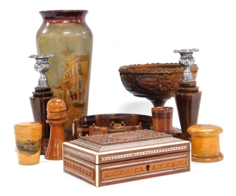 A group of treen, including a Mauchline ware glass holder, printed with a view of Lewes, pair of oak candlesticks, Anglo Indian carved hardwood box, with bone inlay, and a wooden vase painted with a view of Venice. (a quantity)