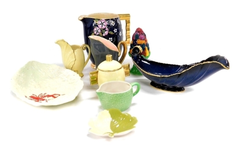 A group of Carltonware pottery, including a powder blue ground jug enamel decorated with flowers and blossom, leaf shaped dish, Art Deco preserve pot and cover, and a fruit basket sugar sifter. (a quantity)