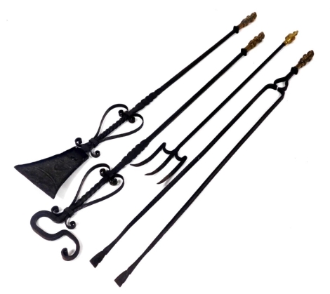 A set of three Victorian brass and cast iron fire implements, with figural monopodia handles, comprising a shovel, pair of tongs, and a scraper, 114cm high, together with a cast iron embers fork with brass urn finial, 90cm high. (4)