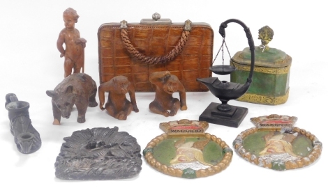 A 19thC Continental carved wooden figure of a putto, black forest carved figure of a bear, two further animal carvings, a painted lead tea caddy, bronze model of a Roman oil lamp, modelled as a shoe, lead navy plaques, etc. (a quantity)