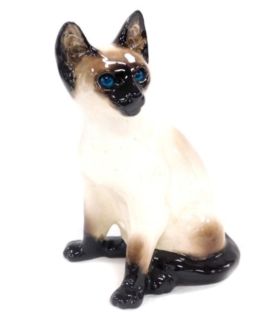 A Winstanley pottery figure of a Siamese cat, modelled in seated pose with blue glass eyes, painted mark, 34cm high.