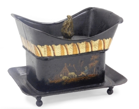 A 19thC Toleware tea caddy, the lid with a flame finial, painted with a band of leaves, above pastoral scenes of figures with cattle and sheep, raised on a tray base, on ball feet, 16cm wide.