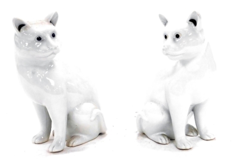 A pair of Chinese white glazed porcelain figures of cats, modelled in seated pose, 20cm high.