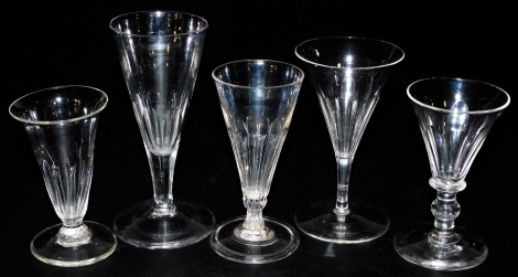 Five 18thC and later glasses, including two dwarf ale glasses with fluted bowls, one with an inverted rim and rough pontil mark, 10.2cm high, the other with a folded foot and smooth pontil, 12cm high, and three other glasses.