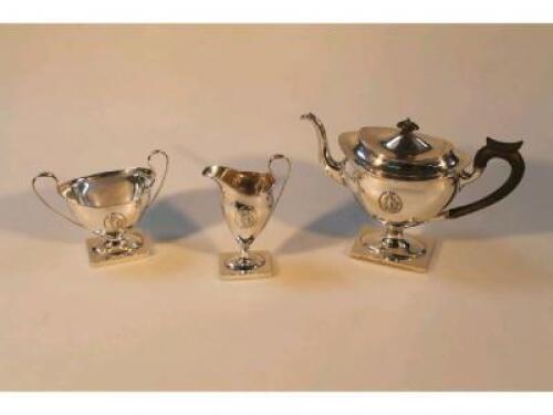 A George V silver neo-classical revival three-piece tea service