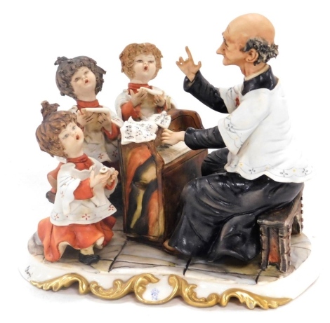 A Capodimonte porcelain figure group, modelled as a choir master and choristers, signed Roci, printed and painted marks, 20cm wide. (AF)