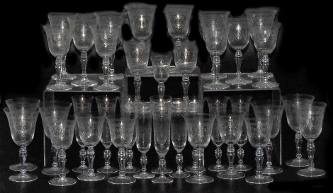 An Edwardian etched glass suite of table glassware, comprising ten champagne flutes, sixteen red wine and ten white wine glasses, and a port glass.