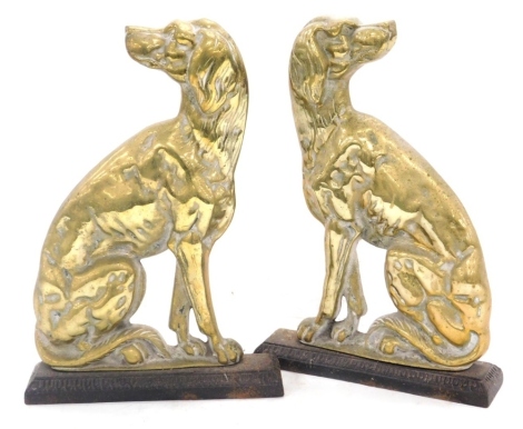 A pair of Victorian brass and iron door stops, modelled as seated greyhounds, 33cm high.