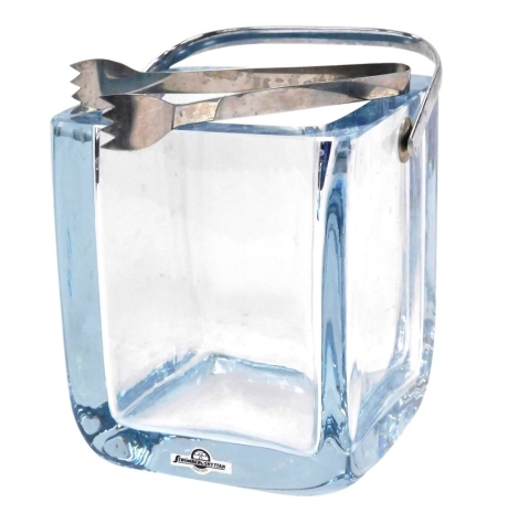 A Strombergshyttan blue glass ice bucket, with swing handle, and pair of ice tongs, bears label, 16cm high.