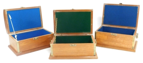 Three teak and brass bound caskets, two with side handles, the other without, each with a vacant interior, 13cm x 25cm x 17cm.