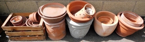 Various terracotta plant pots, differing sizes and designs, together with a concrete plant pot.