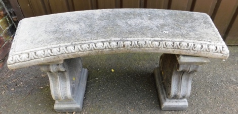 A composition garden bench, the top of arched form, raised on two scroll cast end supports, 53cm high, 112cm wide, 43cm deep.