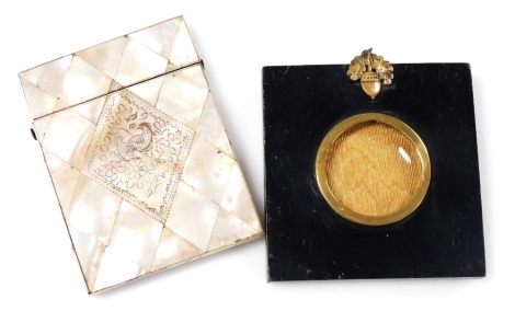 A Victorian mother of pearl calling card case, engraved centrally with bird and flowers, 10cm x 8cm, together with a strut miniature frame. (2)