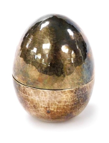 An Elizabeth II silver egg, with a hammered, faceted finish, William A Fipps, London 1975, 2.5oz, 5.5cm high.