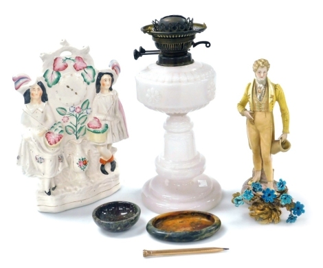 An early 20thC opalescent glass oil lamp, 33cm high, Staffordshire clock face figure group, Continental porcelain figure of a gallant (AF), serpentine and soapstone dishes, a Wahl Eversharp gold plated propelling pencil, and a gilt brass and enamel orname