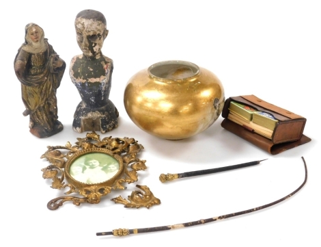 An 18thC Continental parcel gilt wooden carving of a saintly nun, 24cm high, 19thC painted wooden bust of a man, 26cm high, a Regency riding whip, giltwood photograph frame, a playing card set, leather cased, and a glass lamp shade. (6)