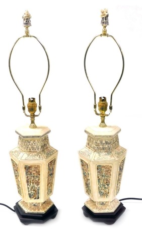 A pair of Chinese bone vase form table lamps, with carved and painted panels of exotic birds and flowers, of hexagonal form, raised on hexagonal wooden bases, 68cm high. Buyer Note: WARNING! This lot contains untested or unsafe electrical items. It is su