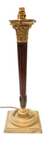 A brass and mahogany Corinthian column table lamp, with a fluted column raised on a square base, 58cm high. Buyer Note: WARNING! This lot contains untested or unsafe electrical items. It is supplied for scrap or reconditioning only. TRADE ONLY