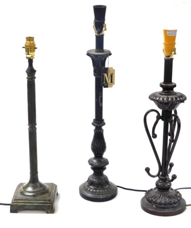 A Minster black column form table lamp, 62cm high, column table lamp, 44cm high, and a further table lamp, 57cm high. (3) Buyer Note: WARNING! This lot contains untested or unsafe electrical items. It is supplied for scrap or reconditioning only. TRADE O