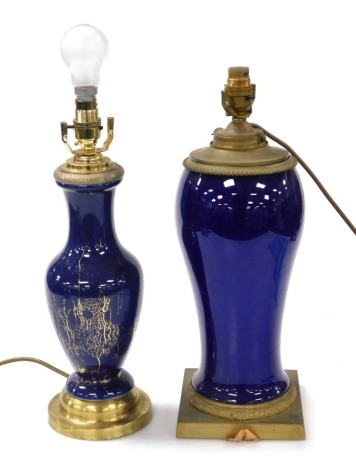 An early 20thC Continental blue ceramic and brass table lamp, 42cm high, and a Continental blue glazed ceramic table lamp of baluster form, with brass mount and circular brass base, 48cm high. (2)