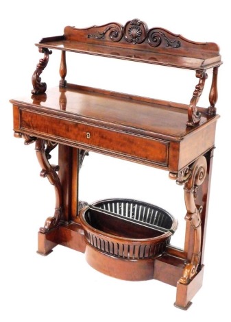 An early Victorian chiffonier, the super structure with a foliate and shell carved crest rail, above a single shelf raised on scrolling foliate supports, over a frieze drawer, above a mirror back base, with demi lune basket, on a plinth base, 125cm x 187c