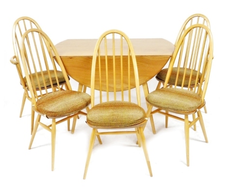 An Ercol light elm drop leaf dining table, 72cm high, 110cm wide, 62cm wide, 122 cm extended, together with five Ercol Windsor dining chairs, comprising a pair of carvers and three single chairs.