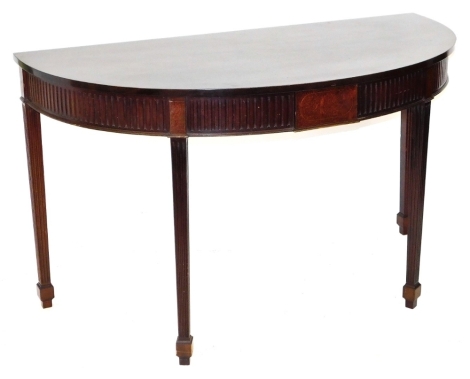 A Georgian style mahogany D end console table, raised on fluted square legs, 86cm high, 146cm wide, 69.5cm deep.