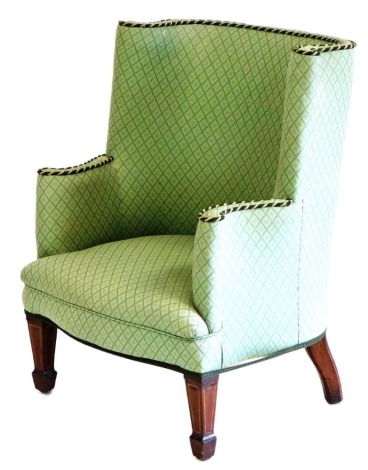 A late Victorian mahogany and satinwood inlaid wingback tub armchair, upholstered in patterned green fabric, raised on tapering square legs and block feet, 68cm wide.